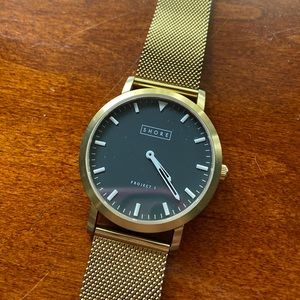 Shore Projects gold watch with black face